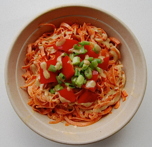 MJ's raw pad thai. Carrot noddles tossed in an almond lime dressing. topped with red bell pepper, green onions and almonds.